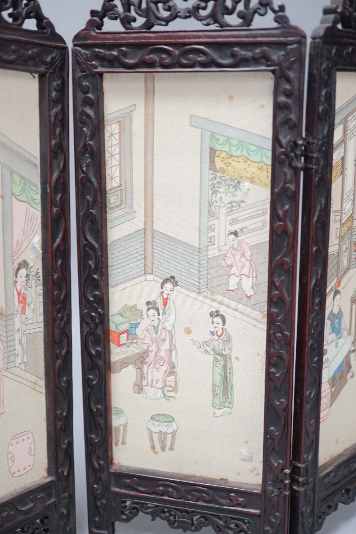 A Chinese hardwood framed painted silk four fold miniature screen, inset with painted silk panels, 28cm